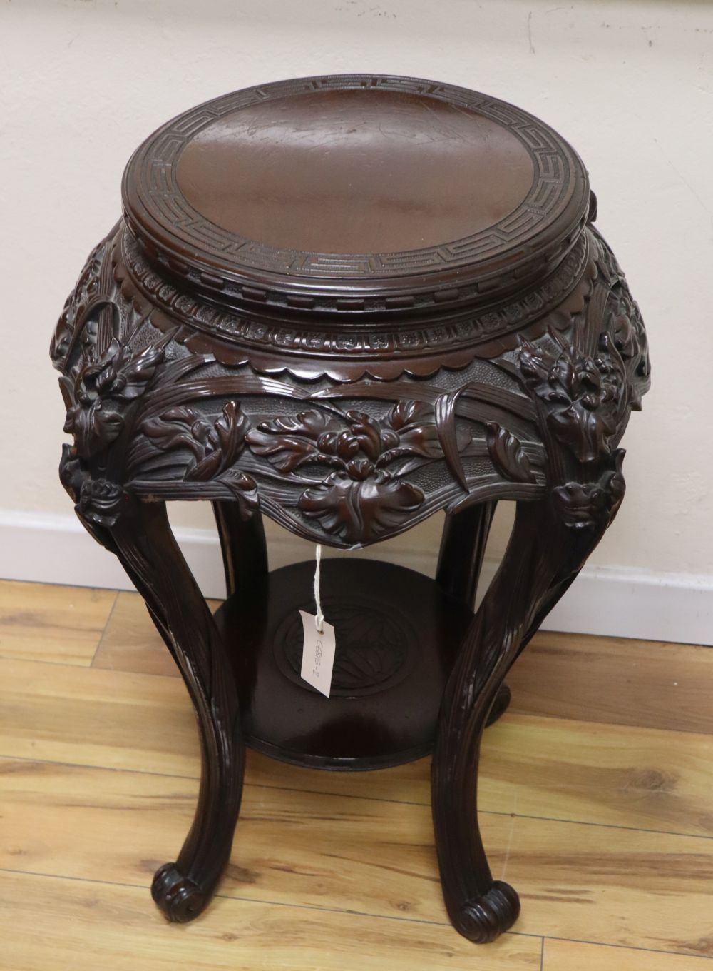 A Japanese lacquered wood stand, Meiji period, 52cm diameter, H.76cm